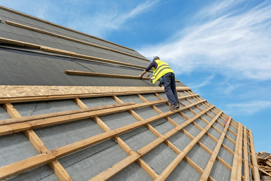 Building construction process of new wooden roof on wood frame house ...